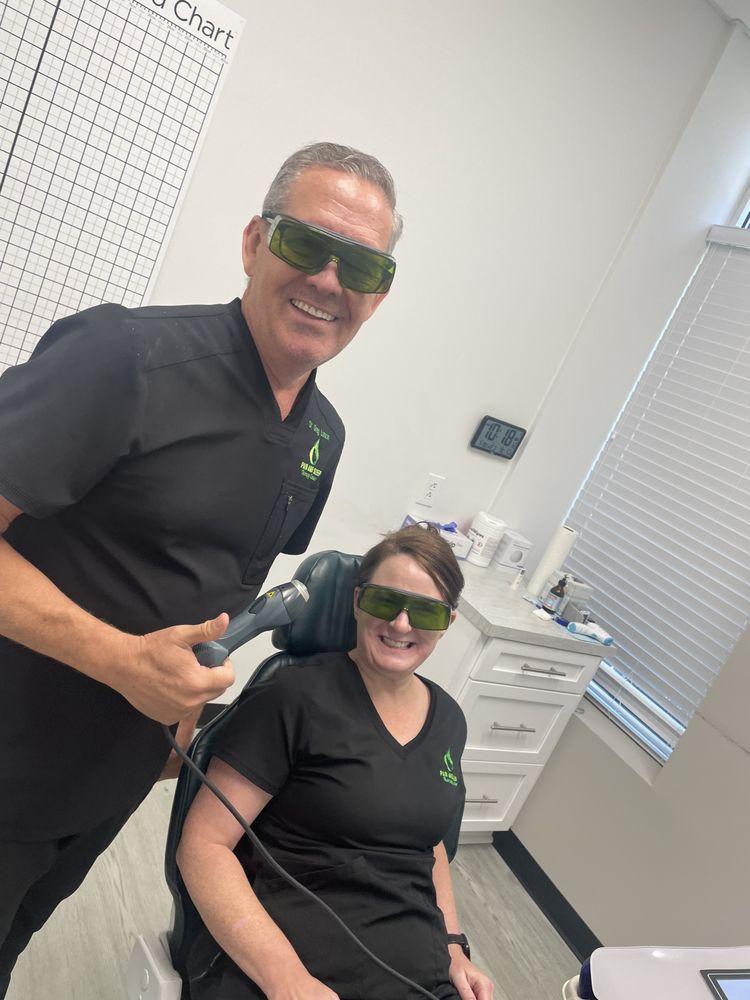 Dr. Greg Larson administering cold laser therapy to a patient.